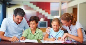 Children with their parents assisting them in the homework